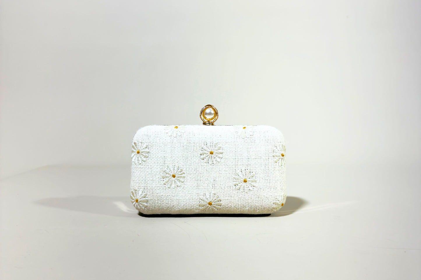 White clutch bag with gold floral embroidery