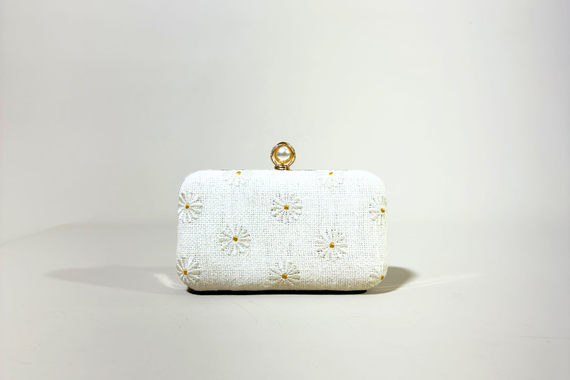 White clutch bag with gold floral embroidery